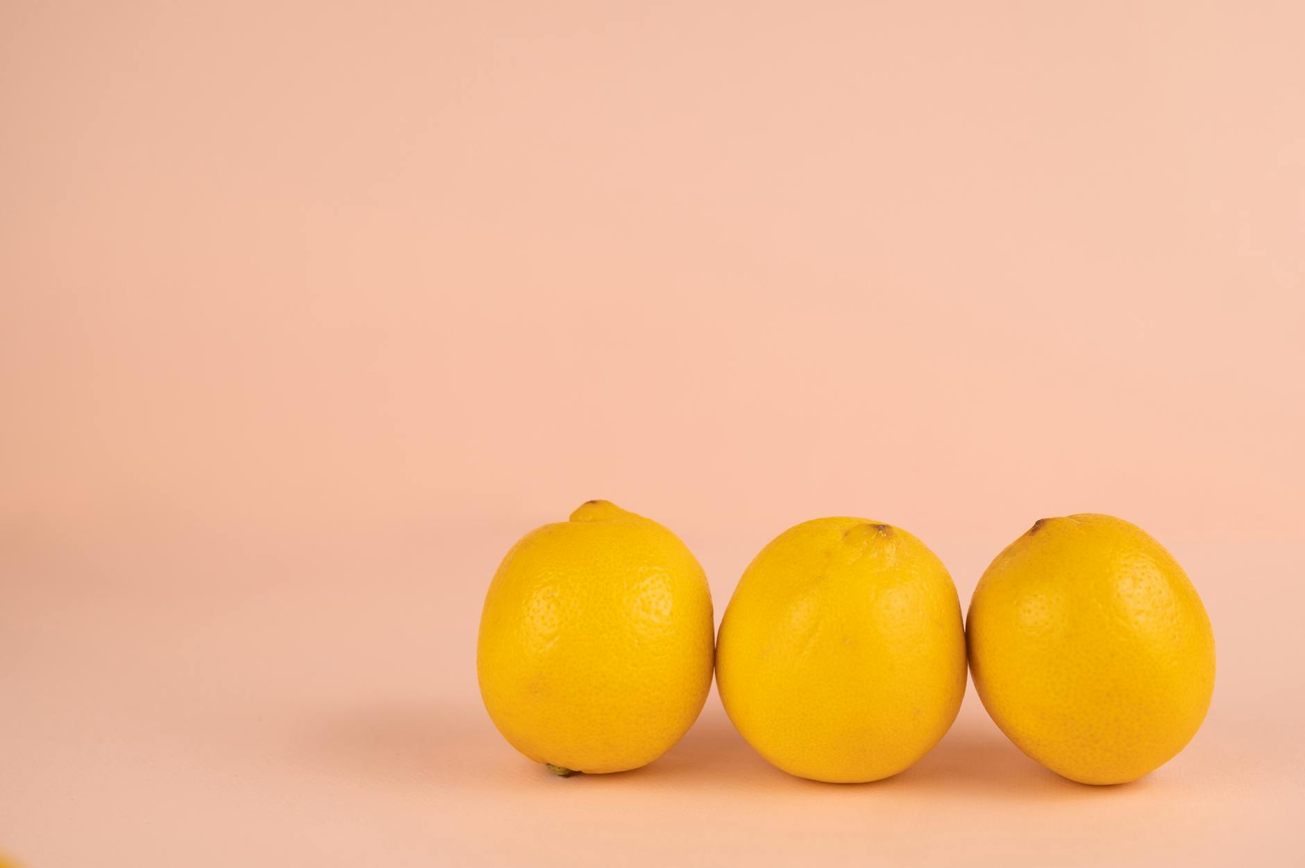 Ripe lemons on pastel background representing fresh, safe sensations